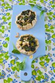 Mini tarts filled with spinach, pine nuts and parmesan