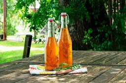 Chilli-infused oil with rosemary in two bottles