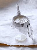 Natural yoghurt being poured through a muslin cloth