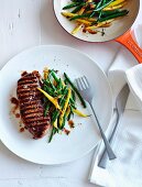 Barbecued beef steak with caramelised beans