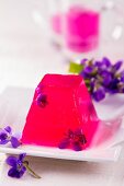 Violet jelly with fresh violet flowers