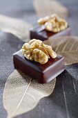 Filled chocolates topped with walnuts