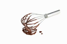 Liquid chocolate dripping off a whisk