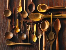 Assorted wooden spoons on a wooden surface
