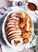 Stuffed turkey roulade with crispy roast potatoes