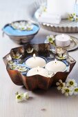 Cake mould used as bowl for floating candles & waxflowers