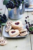 Black-and-white biscuits and heart-shaped biscuits with aronia jam