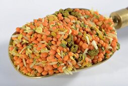 A mix of lentils and rice with herbs and spices on a scoop