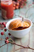 Squash soup with stewed rosehip topped with a squash 'lid'