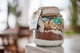 Dry ingredients for making mocha and oat biscuits, in a jar as a gift