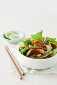 Asian-style salad with crispy salmon pieces