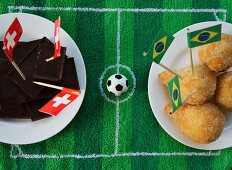 Chocolate (Switzerland) and salgadinhos (Brazil) with football-themed decoration
