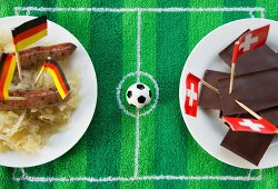 Sausages with cabbage (Germany) and chocolate (Switzerland) with football-themed decoration