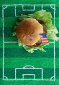 Hamburger with a US flag on a football-field mat