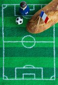 A baguette with a French flag and football-themed decoration