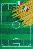 Spaghetti with an Italian flag and football-themed decoration