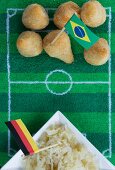 Salgadinhos (Brazil) and sauerkraut (Germany) with football-themed decoration