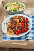 Grilled pork collar steaks with grilled vegetables and salad