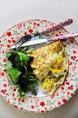 An omelette with smoked fish and salad