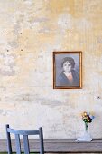 Portrait of child on unpainted wall above wooden table