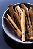 Close-up of hand-made wooden dolly pegs in bowl