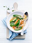 A spring soup with sugar snap peas and carrots