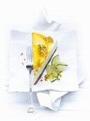 A slice of cheesecake with limes