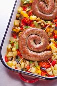Spiral sausages on baked vegetable