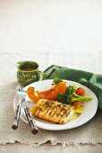 Cajun fish fillet with lemon sauce and vegetables