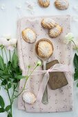 Madeleines and a spoon on a floral napkin with roses