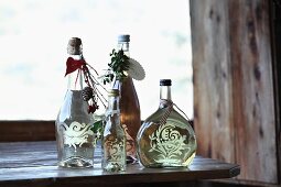 Bottles of wine decorated as gifts with ornaments, pendants and ribbons
