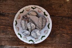 Decorative pebbles printed with plant names as plant markers