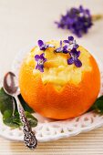 Creamy orange dessert with violets