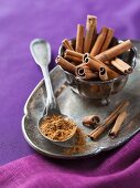 Cinnamon sticks and ground cinnamon on a silver tray