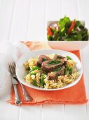 Lamb leg steaks stuffed with spinach, with pasta spirals