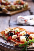 Slice of pizza with olives, feta and anchovies