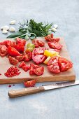 Tomatoes cut into small chunks on a wooden board
