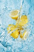 Water being poured over lemons