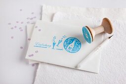 White envelope decorated with various rubber stamp prints