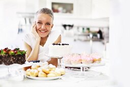 Portrait of woman with selection of hand made cakes