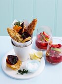 Fish and chips with vegetable chips and fried parsley served with fruit punch