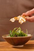 Satay skewers with fish and rocket