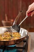 Trout fritters being fried in a pan