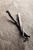 Vanilla pods on a grey surface