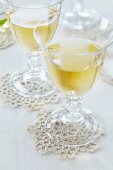 Crocheted doilies used as coasters for wine glasses