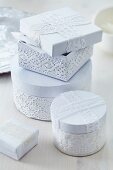 Cartons decorated with white lace trim as romantic gift boxes