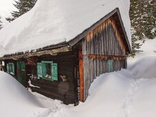 Verschneite Almhütte