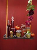 An autumnal still life featuring bottled vegetables and fruit