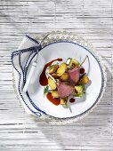 Saddle of lamb with fried potatoes and courgette rolls