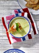 Courgette soup with a prawn skewer